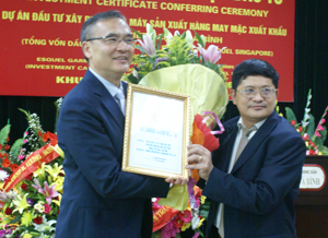 Lãnh đạo BQL các KCN tỉnh trao giấy chứng nhận đầu tư cho dự án Esquel SX hàng may mặc dầu tư tại KCN Lương Sơn. Ảnh: L.C