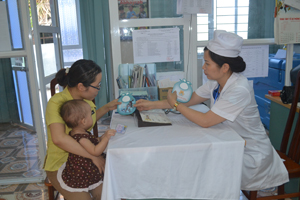 Cán bộ Trung tâm YTDP tỉnh tư vấn cách phòng bệnh viêm não Nhật Bản cho bà mẹ trẻ em. 


